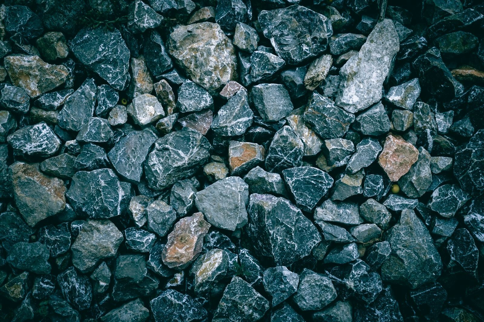 Dark crushed basalt-type rock in broken pieces
