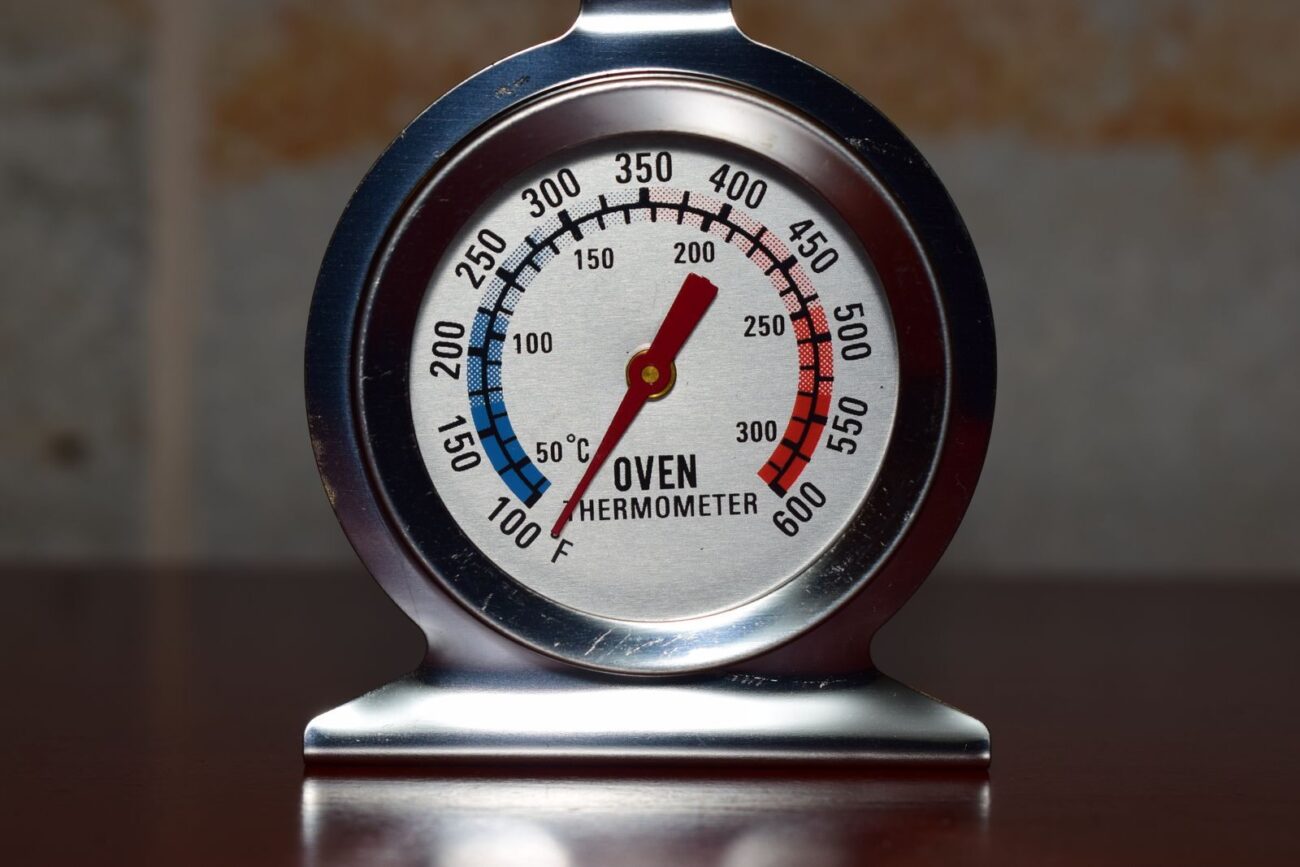 Oven thermometer showing temperature ranges representing the critical role of temperature and heating rate in determining whether slow or fast pyrolysis produces biochar bio-oil or syngas from biomass feedstock
